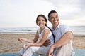 Hispanic father and daughter having fun at beach