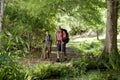 Hispanic father and son hiking on trail in woods Royalty Free Stock Photo