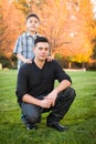 Hispanic Father and Son Portrait Against Fall Colored Trees