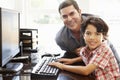 Hispanic father and son using computer at home Royalty Free Stock Photo