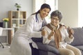 Hispanic female doctor and old lady patient gesturing thumbs up to camera