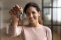 Hispanic female happy homeowner look at camera celebrate getting mortgage