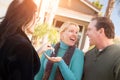 Hispanic Female Real Estate Agent Handing Over New House Keys to Happy Couple In Front of House Royalty Free Stock Photo