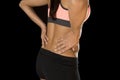 Hispanic fitness woman touching and grabbing her lower back suffering back pain Royalty Free Stock Photo