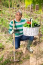 Hispanic gardener proud of harvest of vegetables Royalty Free Stock Photo