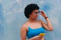 Hispanic girl with a blue blouse in front of a blue background Royalty Free Stock Photo