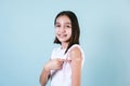 Hispanic girl child portrait after getting a vaccine protection and showing her arm with bandage receiving vaccination on blue bac Royalty Free Stock Photo