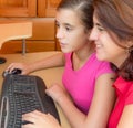 Hispanic girl and her mother working on a computer Royalty Free Stock Photo