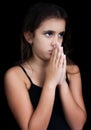 Hispanic girl praying isolated on black Royalty Free Stock Photo