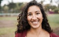 Hispanic girl smiling on camera outdoor in city park - Focus on face Royalty Free Stock Photo