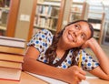 Hispanic Girl Student Daydreaming While Studying in Library Royalty Free Stock Photo