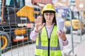 Hispanic girl wearing architect hardhat at construction site with open hand doing stop sign with serious and confident expression, Royalty Free Stock Photo
