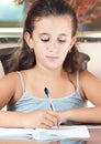 Hispanic girl wrting in a notebook