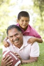 Hispanic Grandfather With Grandson In Park