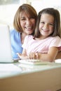 Hispanic Grandmother Using Laptop And Calculator With Granddaughter Royalty Free Stock Photo