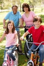 Hispanic grandparents with grandchildren on bikes Royalty Free Stock Photo