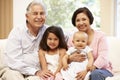 Hispanic Grandparents At Home With Grandchildren