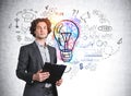 Hispanic handsome businessman in formal suit holding a planner and pondering about new start up nearby concret wall with colorful Royalty Free Stock Photo