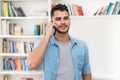 Hispanic hipster man in quarantine talking at mobile phone Royalty Free Stock Photo