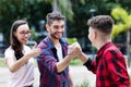 Hispanic hipster young adult giving highfive to friend Royalty Free Stock Photo