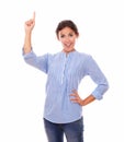 Hispanic lady pointing up while standing Royalty Free Stock Photo