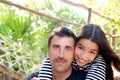 Hispanic latin father and teen daughter hug park