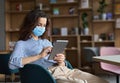 Hispanic latin young woman student wearing mask using digital tablet. Royalty Free Stock Photo