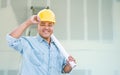 Hispanic Male Contractor with Blueprint Plans Wearing Hard Hat In Front of Drywall and Ladder