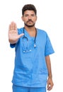 Hispanic male nurse with beard gesturing stop for distance Royalty Free Stock Photo