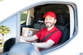 Hispanic male worker working as a delivery driver Royalty Free Stock Photo