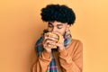 Hispanic man with afro hair smelling coffee aroma relaxed with eyes closed Royalty Free Stock Photo