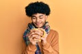 Hispanic man with afro hair smelling coffee aroma relaxed with eyes closed Royalty Free Stock Photo