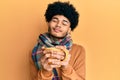 Hispanic man with afro hair smelling coffee aroma relaxed with eyes closed Royalty Free Stock Photo