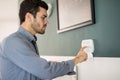 Hispanic man arming his alarm system Royalty Free Stock Photo