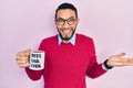 Hispanic man with beard drinking mug of coffee with best dad ever message celebrating achievement with happy smile and winner