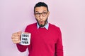 Hispanic man with beard drinking mug of coffee with best dad ever message scared and amazed with open mouth for surprise,