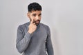 Hispanic man with beard standing over white background pointing to the eye watching you gesture, suspicious expression Royalty Free Stock Photo