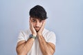 Hispanic man with beard standing over white background tired hands covering face, depression and sadness, upset and irritated for Royalty Free Stock Photo