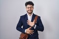 Hispanic man with beard wearing business clothes smiling and laughing hard out loud because funny crazy joke with hands on body Royalty Free Stock Photo