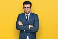 Hispanic man with beard wearing business suit and tie skeptic and nervous, disapproving expression on face with crossed arms Royalty Free Stock Photo