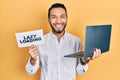 Hispanic man with beard working using computer laptop holding lazy loading banner smiling with a happy and cool smile on face Royalty Free Stock Photo