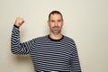 Hispanic man with a beard of 40 years old showing biceps believing that his training has paid off, the poor deluded man Royalty Free Stock Photo