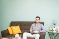 Hispanic man drinking tea in a waiting room Royalty Free Stock Photo