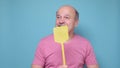 man with fly swatter trying to kill mosquito on blue background. Royalty Free Stock Photo