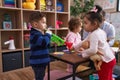 Hispanic man and group of kids having music class standing at kindergarten Royalty Free Stock Photo