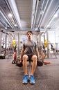 Hispanic man in gym sitting on bench, working out with weights Royalty Free Stock Photo