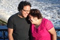 Hispanic man and his mother laughing by a river Royalty Free Stock Photo