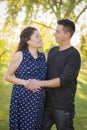 Hispanic Man With His Pregnant Wife Outdoors At the Park Royalty Free Stock Photo