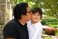 Hispanic man kissing his adorable son outdoors Royalty Free Stock Photo