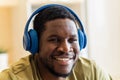 hispanic man listening music in wireless headphones at home Royalty Free Stock Photo